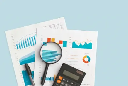 Detailed financial analysis with charts and a magnifying glass, highlighting robust assurance-controls and regulatory compliance services