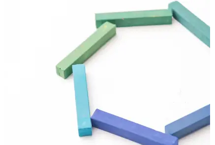 Different colored shapes forming a new polygon, symbolising skillful Merger & Acquisition (M&A) divestiture strategy and execution
