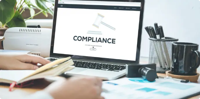 Laptop screen displaying compliance, symbolizing expert financial risk management and regulatory compliances advisory