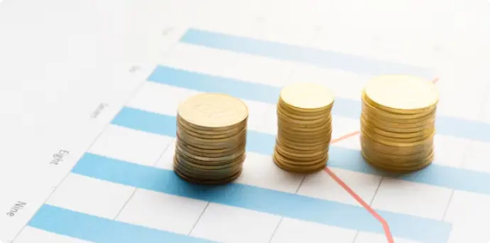Stacks of gold coins on an upward trend graph, highlighting strict and lawful regulatory compliance services
